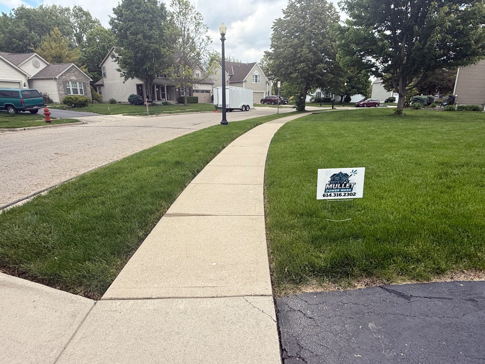 Freshly pressure washed concrete sidewalk and front walk in a Central Ohio neighborhood