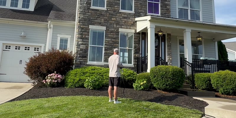 Mullet Power Wash technician soft washing a stone-front home in Central Ohio